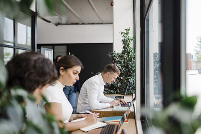 Business people working together using laptop in modern office