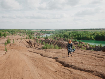 Rear view of man riding bicycle on landscape