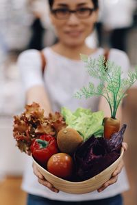 Close-up of woman holding vegetables