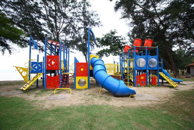 Playground in park against sky