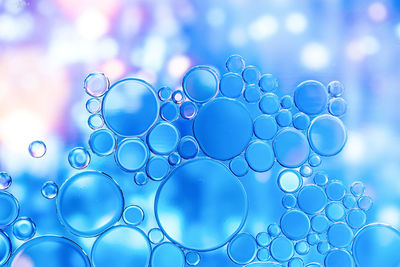 Close-up of bubbles against blue sky