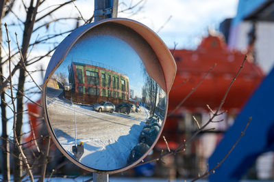 Mirror of spherical type on telegraph pole reflecting road. large convex mirror on road. convex