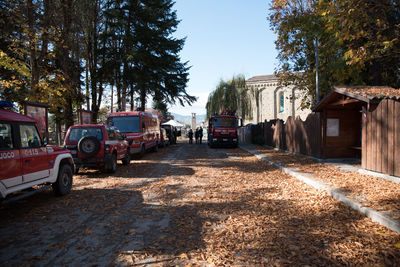 Cars on street in city against sky