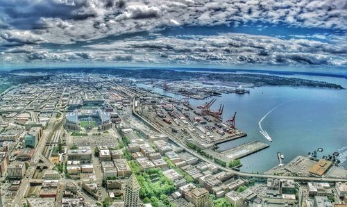 High angle view of buildings by sea against sky
