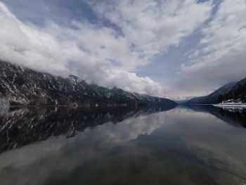 Scenic view of lake by mountain against sky