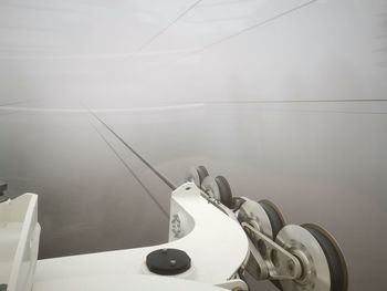 Close-up of overhead cable car during fog