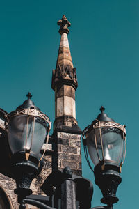 Low angle view of street light against building