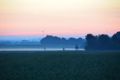 Scenic view of field against sky during sunset