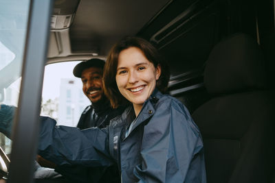 Portrait of young woman sitting in car