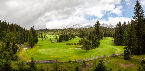 Panoramic view of golf course against sky