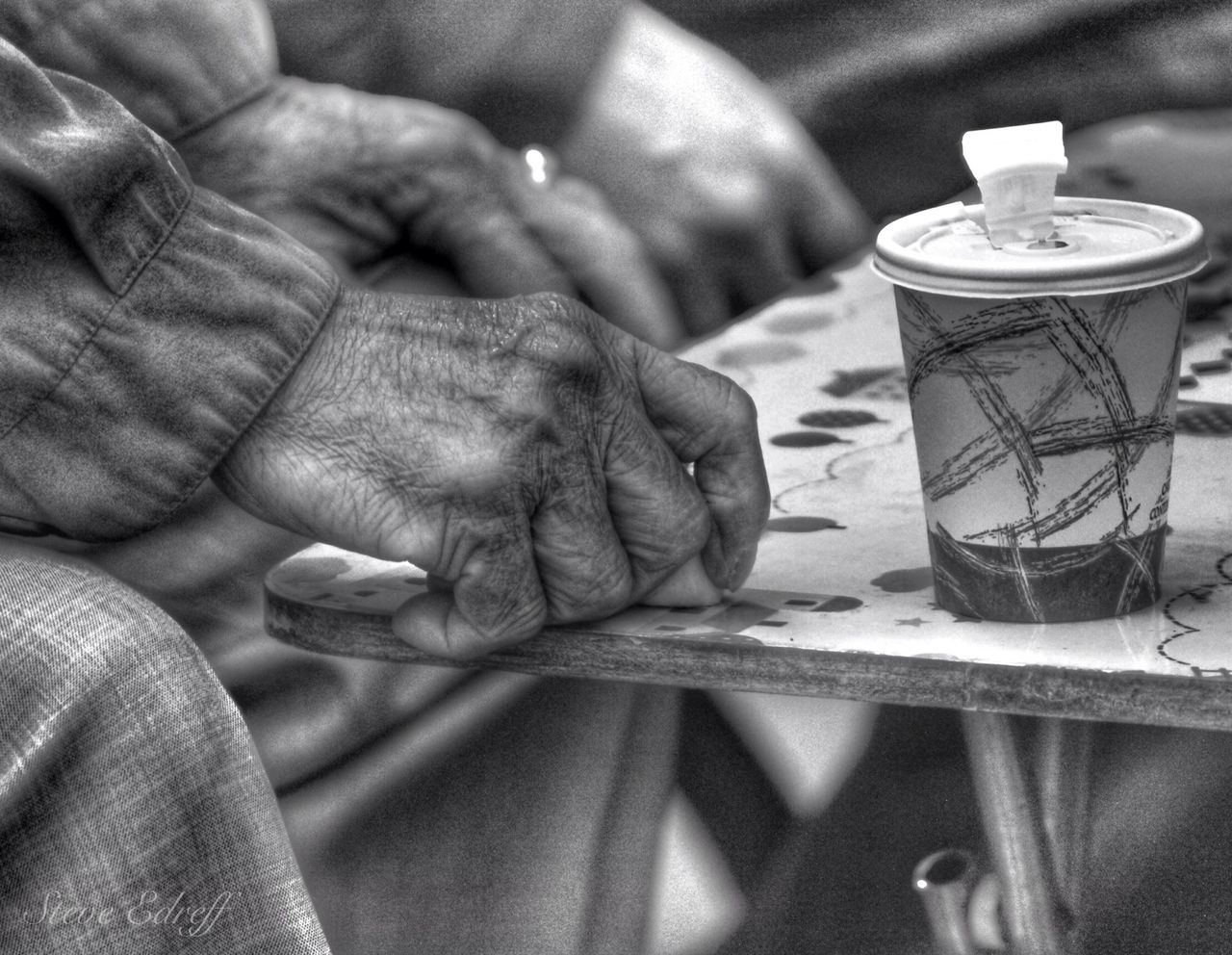 indoors, person, food and drink, close-up, table, focus on foreground, holding, part of, men, drink, midsection, cropped, selective focus, unrecognizable person, freshness, container