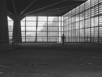 Silhouette mid adult man standing in abandoned building