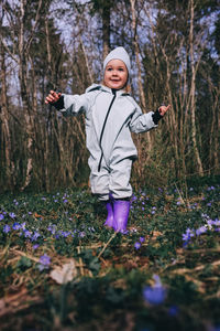 Portrait of young woman standing amidst plants