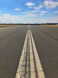 Runway against cloudy sky