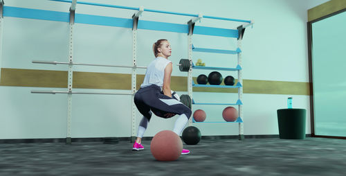 Low section of woman exercising in gym