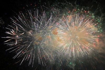 Low angle view of firework display at night