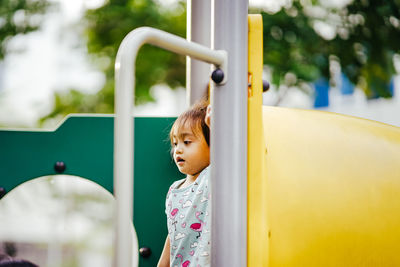Cute girl looking at playground