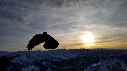 Scenic view of snowcapped mountains against sky during sunset