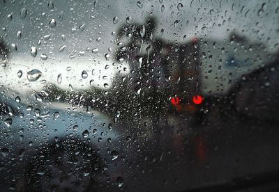 Full frame shot of wet glass window in rainy season