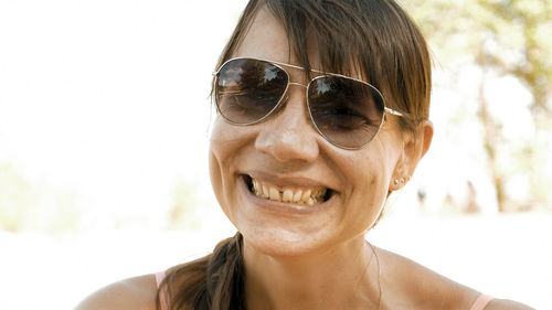 Portrait of smiling young woman wearing sunglasses
