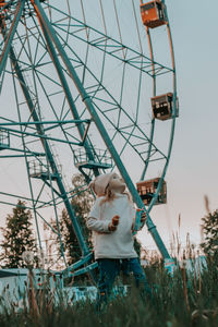 Low angle view of ferris wheel against sky