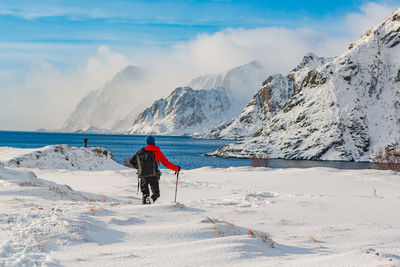 Rear view of man on snow covered land