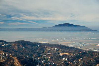 High angle view of city and mountains against sky
