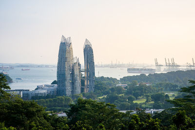 Buildings in city against clear sky