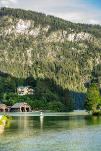 Scenic view of lake by trees against mountain