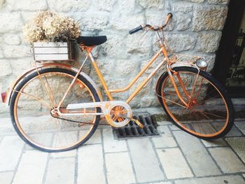 High angle view of bicycle parked on footpath against wall