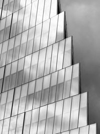 Low angle view of modern building against cloudy sky