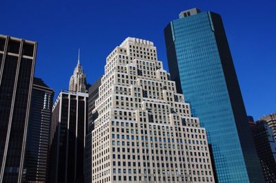 Low angle view of buildings against blue sky