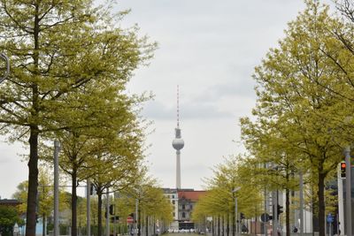 Low angle view of communications tower in city