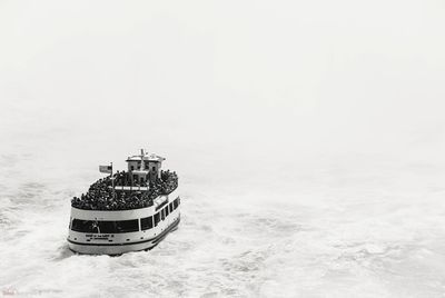 Boat sailing on sea against sky