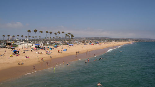 People at beach against sky