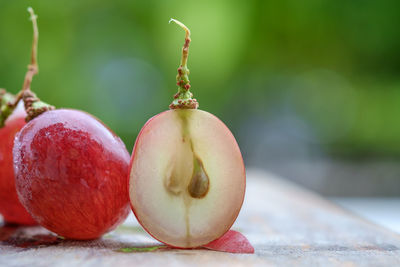 Close-up of red grapes on table outdoors