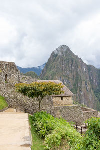 Built structure on mountain against cloudy sky