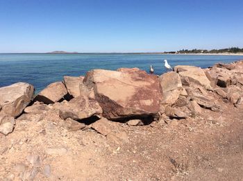 Scenic view of sea against clear blue sky