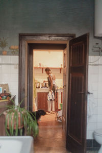 Rear view of woman standing in room