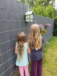 Girls standing by wall