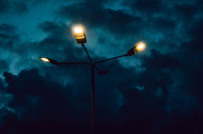 Low angle view of illuminated street light against sky at night