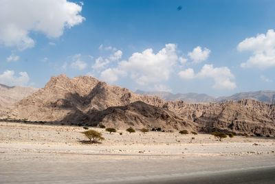 Scenic view of mountains against cloudy sky