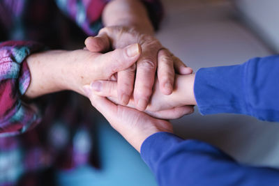 Midsection of couple holding hands