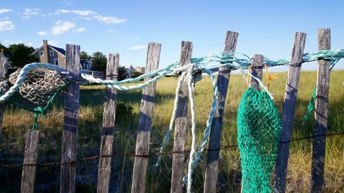 Close-up of fishing net against blue sky