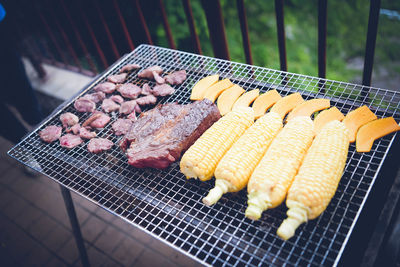 High angle view of meat on barbecue grill