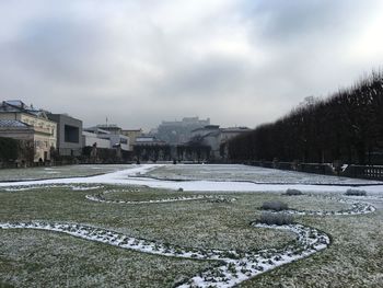 Snow covered city against sky