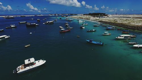 High angle view of boats moored in sea against sky