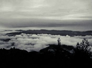 Scenic view of mountains against cloudy sky