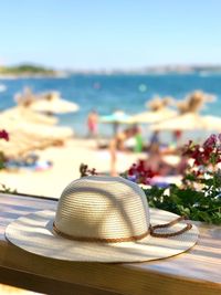 Close-up of hat on beach against clear sky