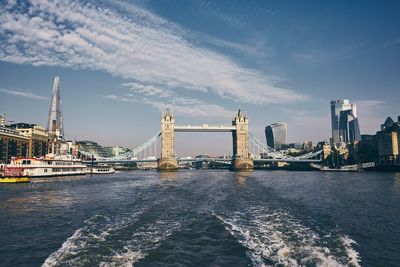 Bridge over river with city in background